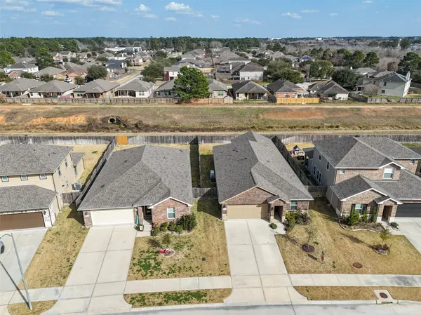an aerial view of a residential houses with outdoor space