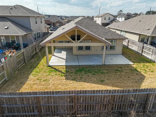 a view of a house with wooden fence