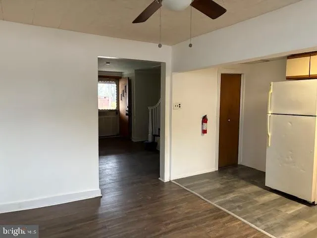 a view of a hallway with wooden floor and closet