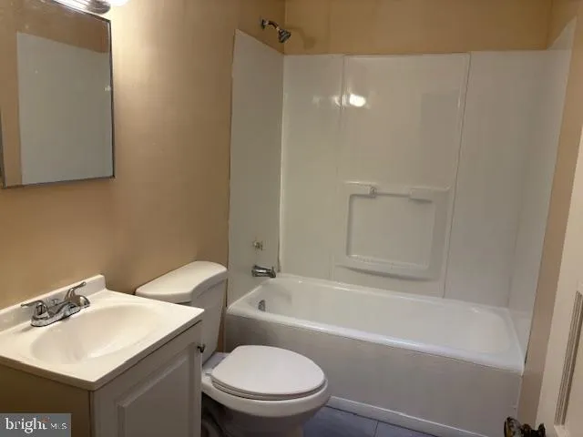 a bathroom with a sink toilet vanity and bathtub