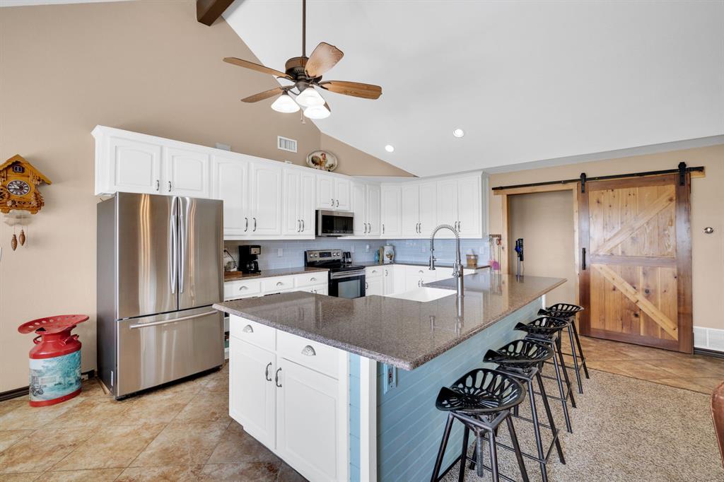 130 Eubanks Road Maypearl, TX 76064 - Photo 20 of 39 a kitchen with refrigerator cabinets and wooden floor