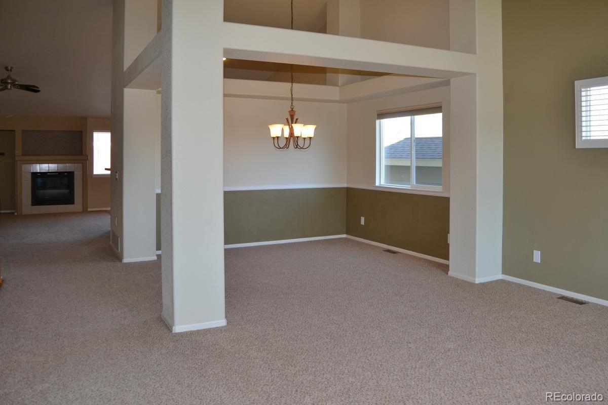 8039 Raspberry Drive Frederick, CO 80504 - Photo 4 of 28 an empty room with windows and entrance