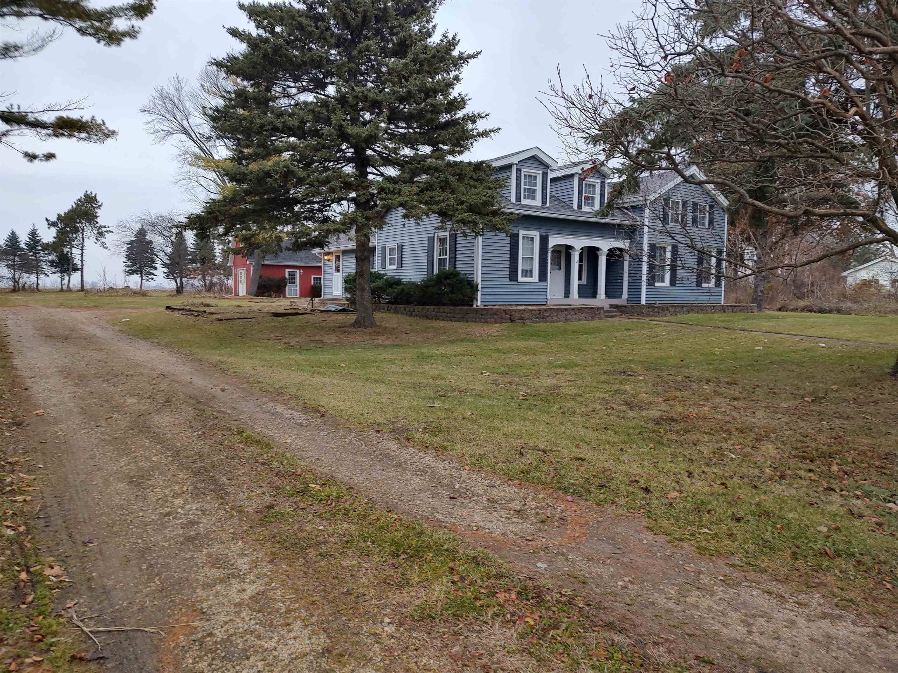 11090 Woodstock Road Garden Prairie, IL 61038 - Photo 2 of 37 a front view of a house with a garden and trees
