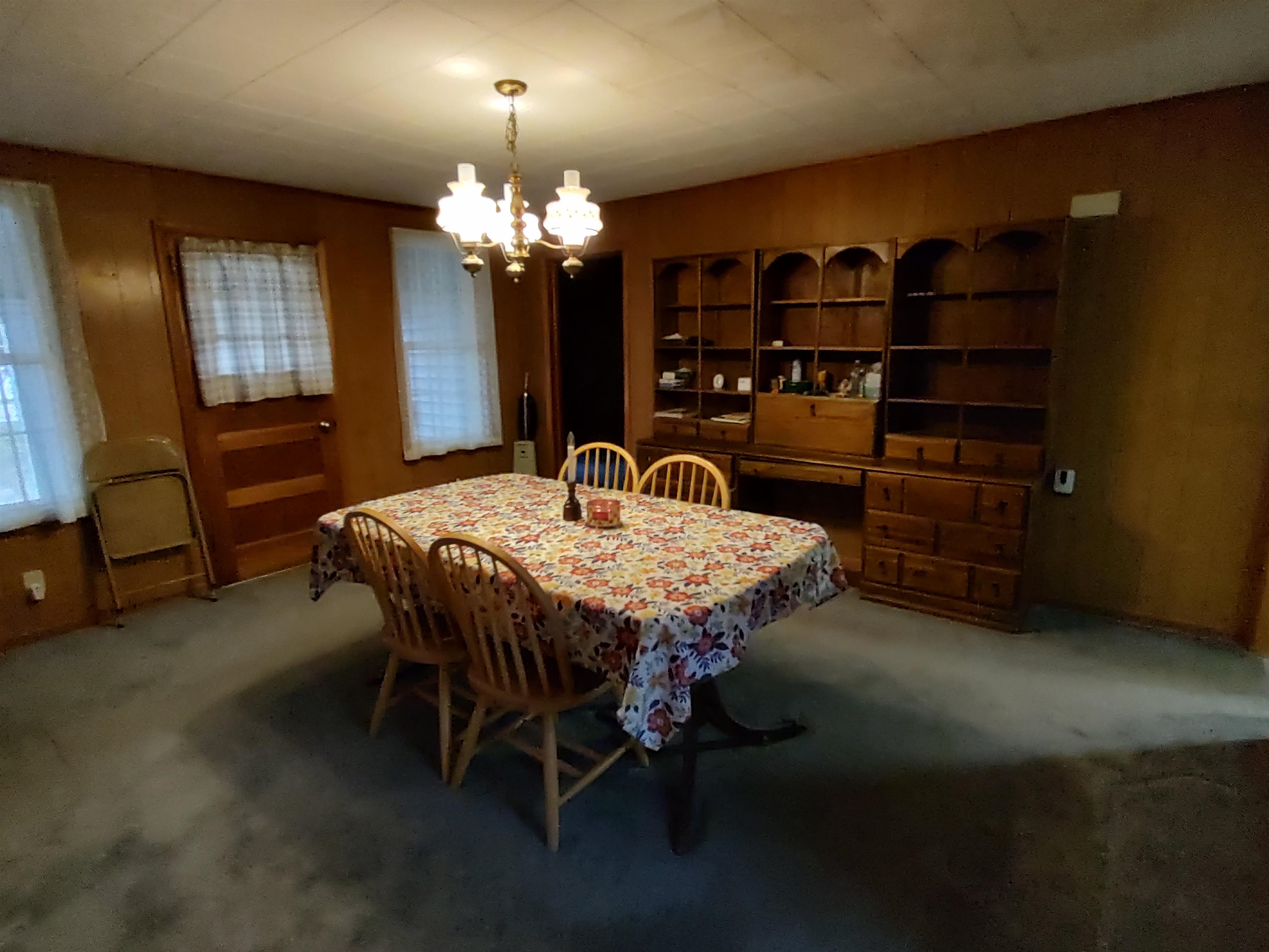 11090 Woodstock Road Garden Prairie, IL 61038 - Photo 30 of 37 a dining room with furniture and chandelier
