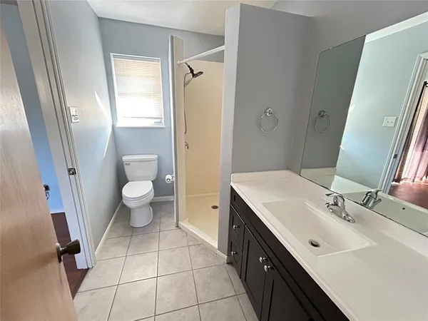 a spacious bathroom with a sink toilet and shower