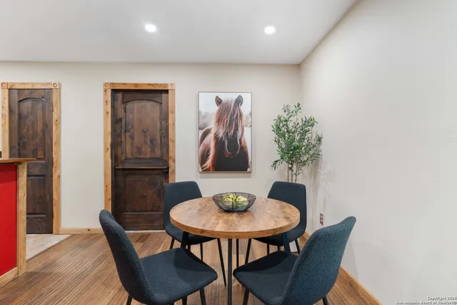 a view of a dining room with furniture and wooden floor