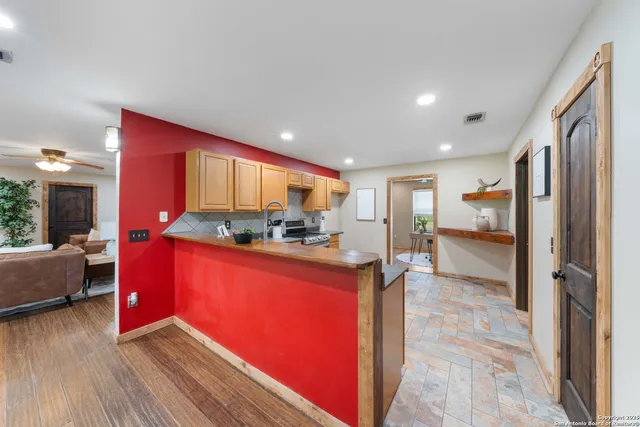 a kitchen with stainless steel appliances granite countertop a refrigerator and a stove