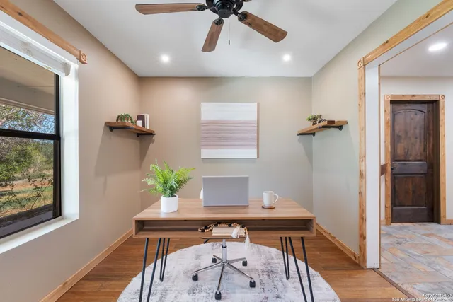a view of workspace with furniture and a window