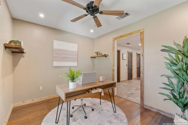 a workspace with furniture and a potted plant