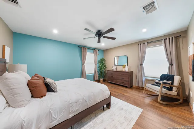 a bedroom with a bed a couch and a window