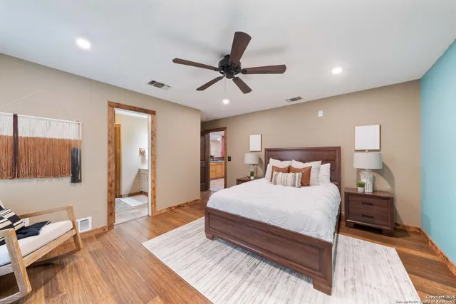 a bedroom with a bed and wooden floor