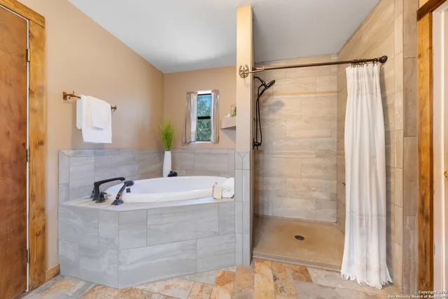 a bathroom with a shower and a sink