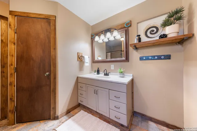 a bathroom with a sink a vanity and a mirror