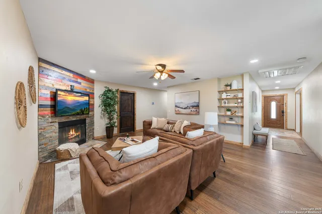 a living room with furniture fireplace and flat screen tv