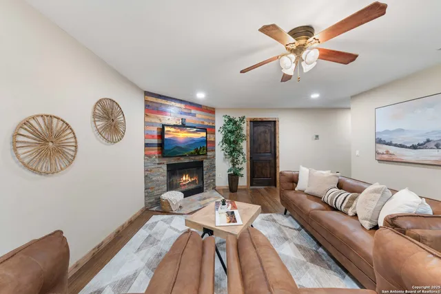 a living room with furniture a rug and a flat screen tv