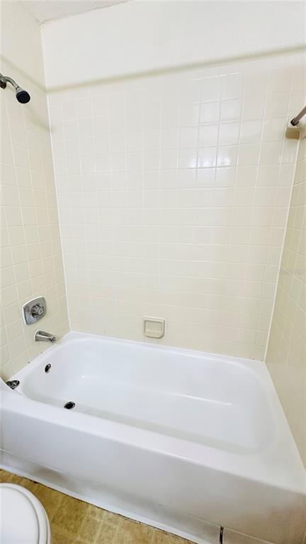 1017 South Hiawassee Road, Unit 3716 Orlando, FL 32835 - Photo 13 of 20 a bathroom with a bathtub and a shower