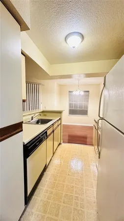 a kitchen with stainless steel appliances granite countertop a stove and a refrigerator