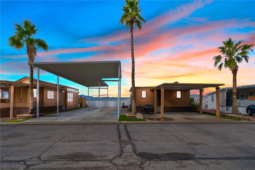 Property at dusk featuring a carport
