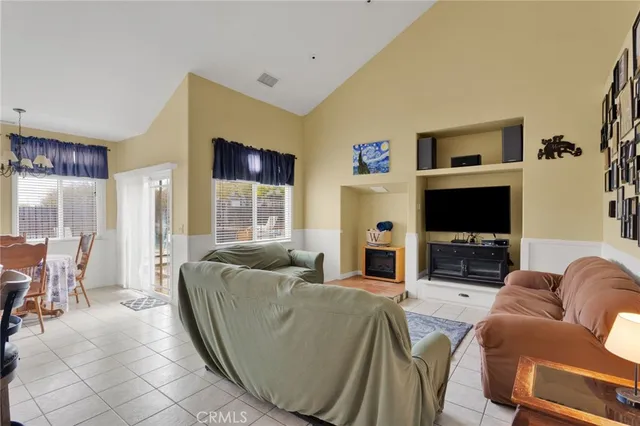 a living room with furniture cabinets and a flat screen tv