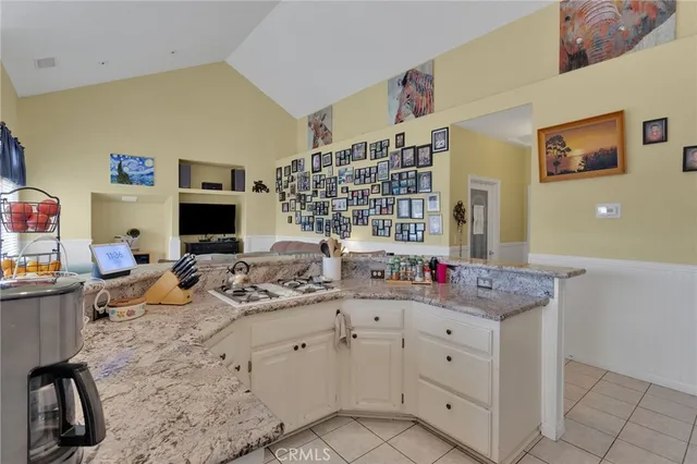 a kitchen with sink cabinets and chairs