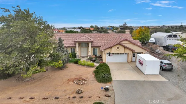 a view of a swimming pool with lawn chairs and potted plants