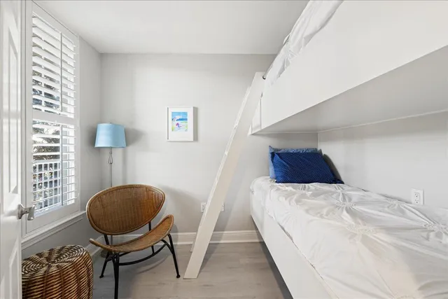 a view of a bedroom with a bed and chair