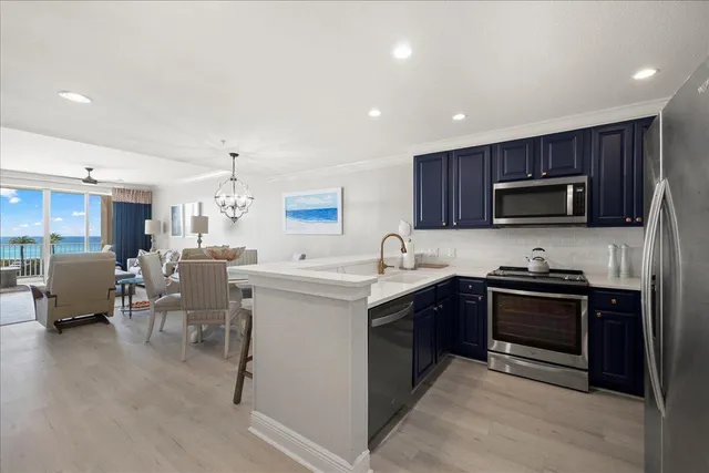 a kitchen with a sink stainless steel appliances and cabinets