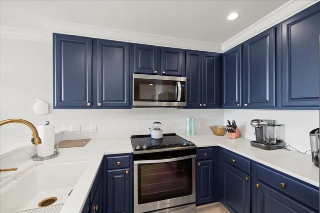a kitchen with wooden cabinets and stainless steel appliances