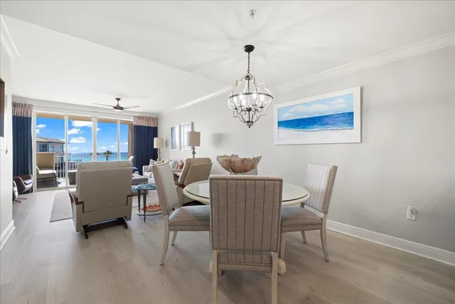a view of a dining room with furniture and chandelier