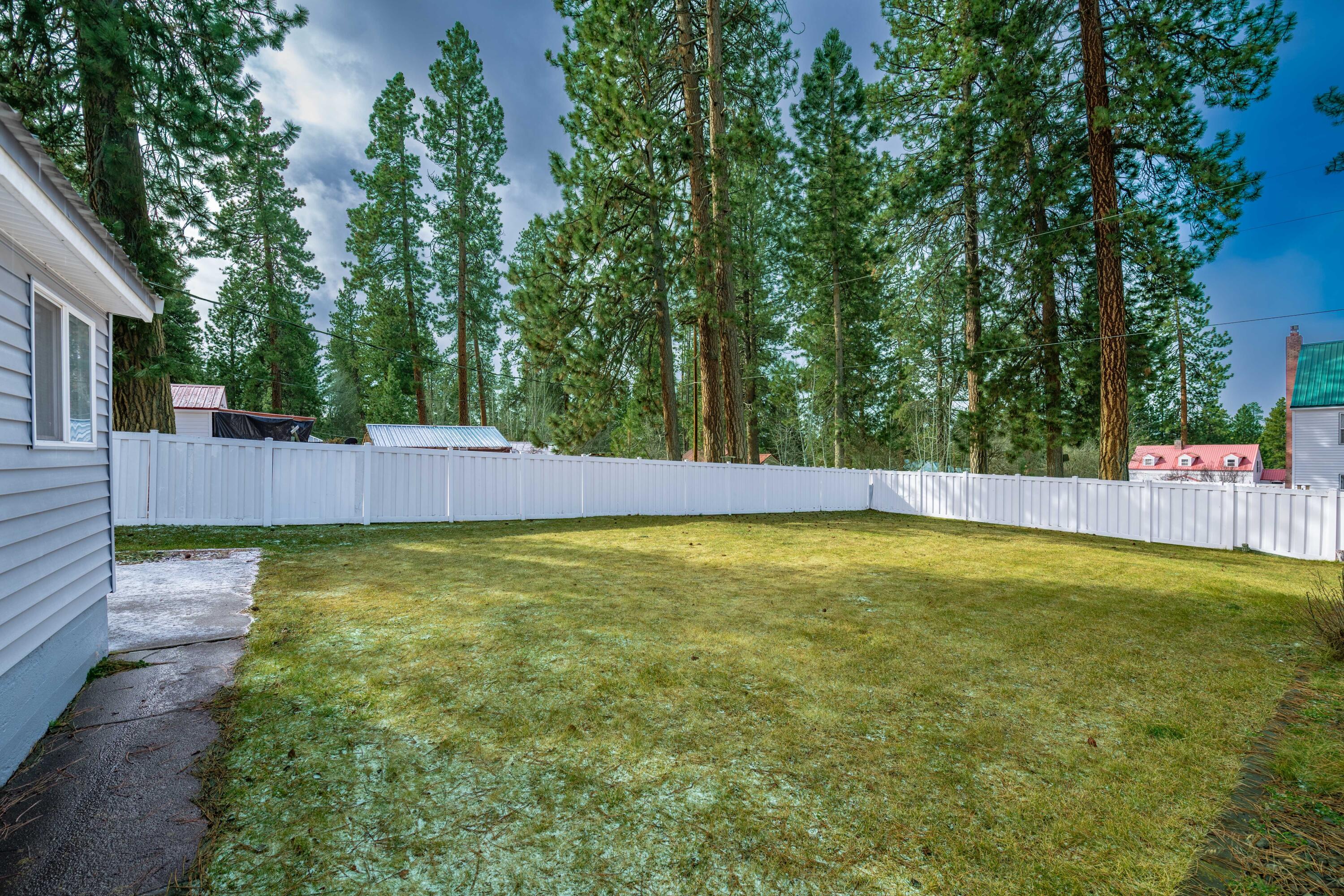 138722 Rhododendron Street Gilchrist, OR 97737 - Photo 7 of 36 a view of yard with swimming pool and trees in the background