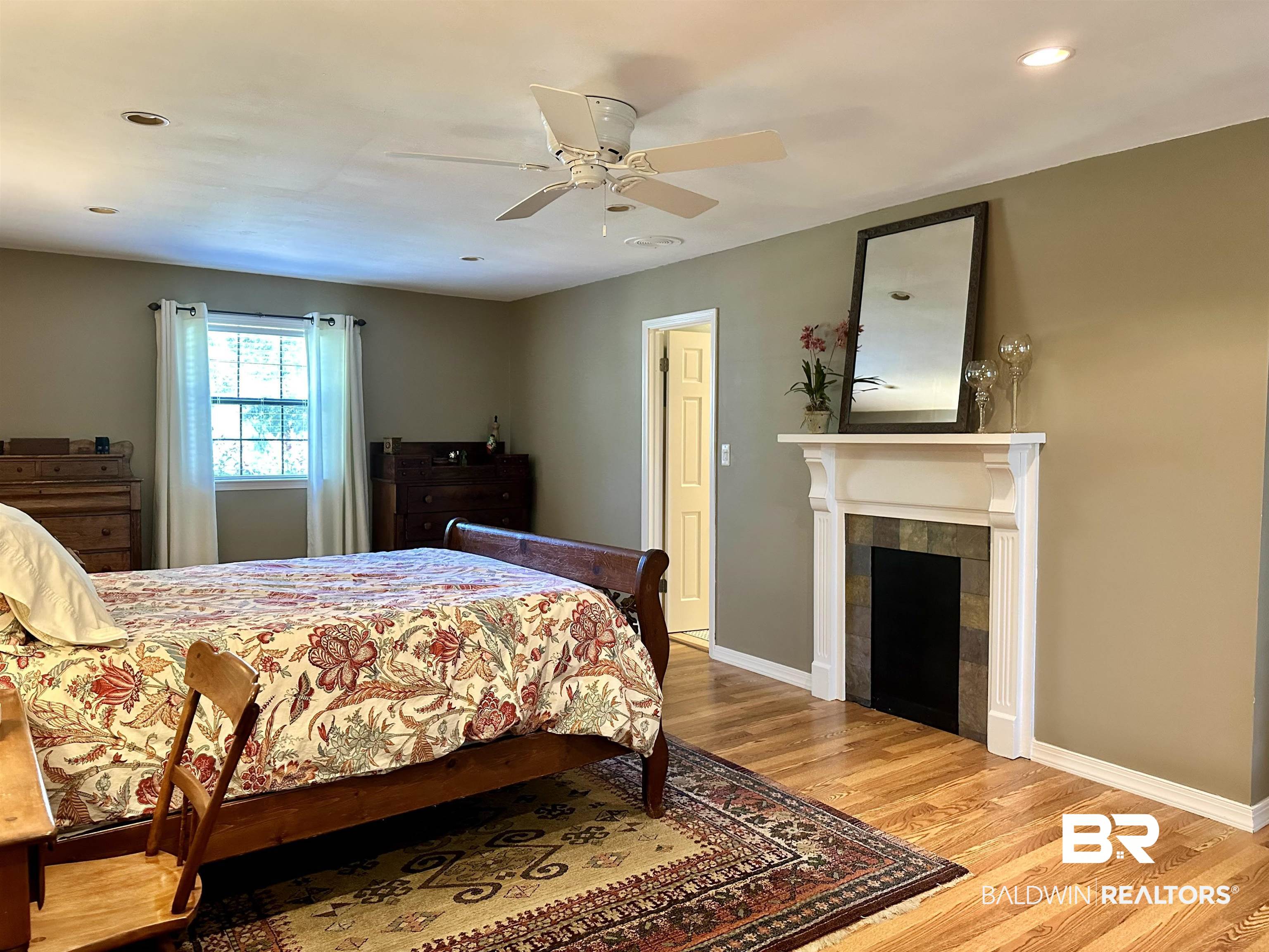 117 Belle Meade Brewton, AL 36426 - Photo 17 of 62 Bedroom with a fireplace, ceiling fan, and light hardwood / wood-style floors