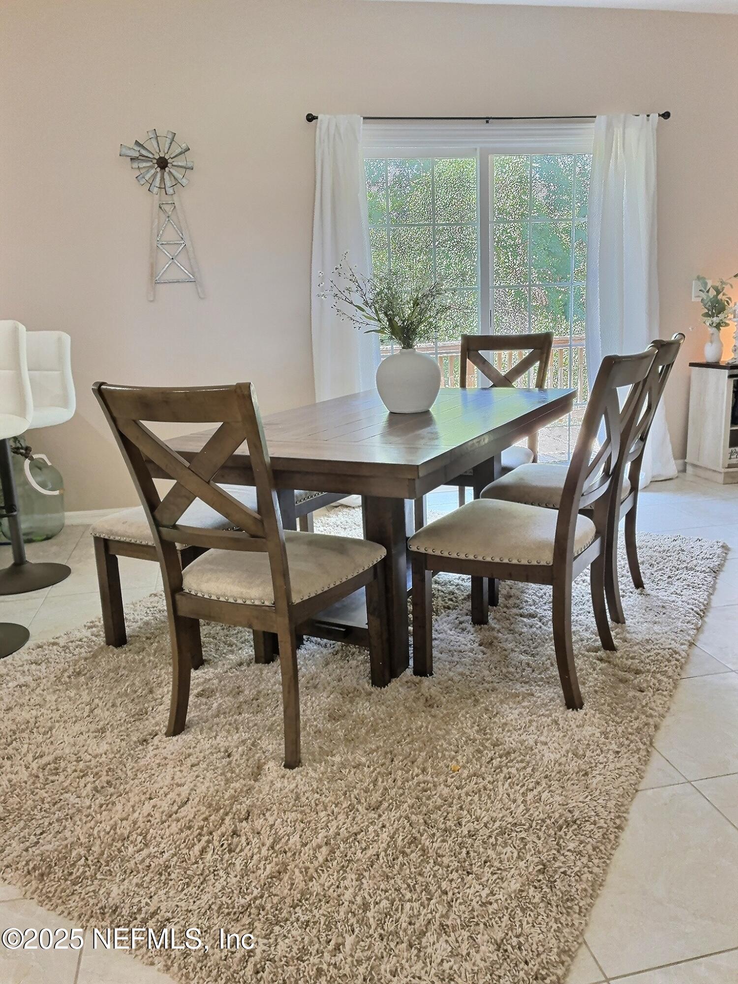 224 Crocus Lane Hawthorne, FL 32640 - Photo 13 of 58 a dining room with furniture and a floor to ceiling window