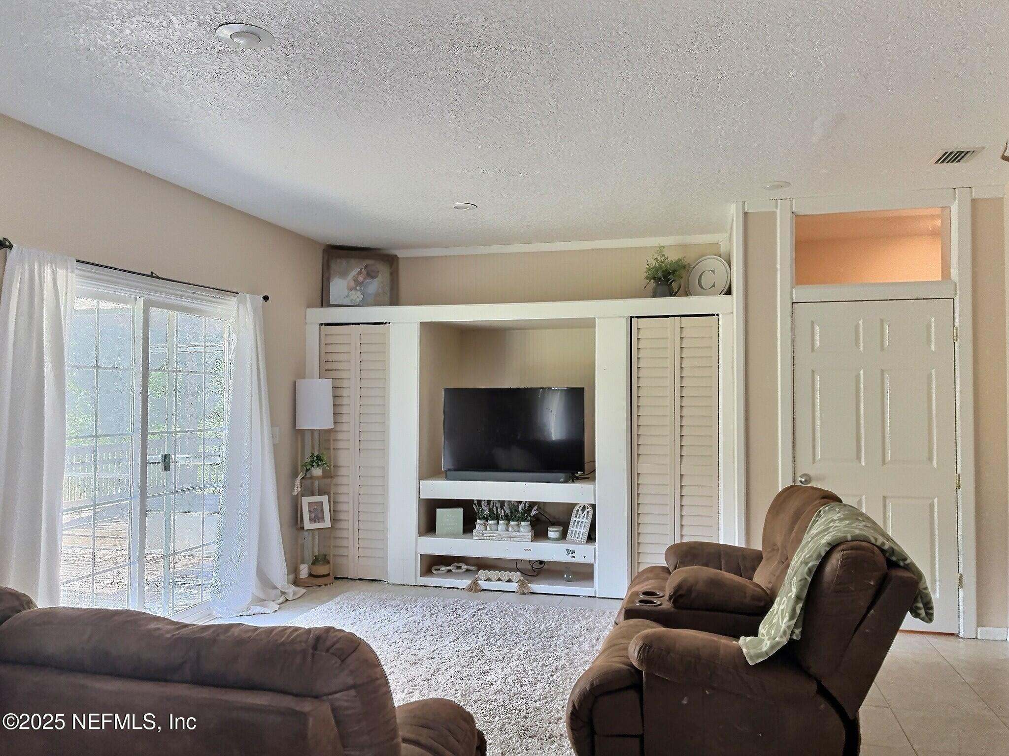 224 Crocus Lane Hawthorne, FL 32640 - Photo 20 of 58 a living room with furniture and a flat screen tv