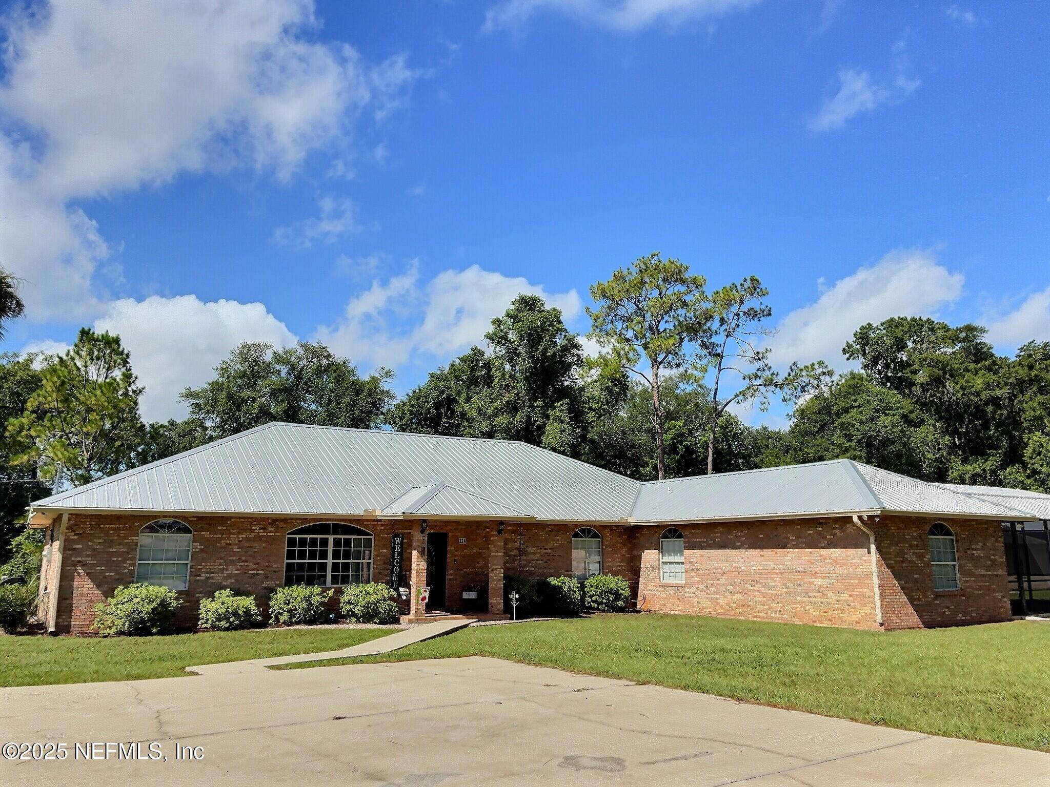 224 Crocus Lane Hawthorne, FL 32640 - Photo 2 of 58 a house with trees in the background