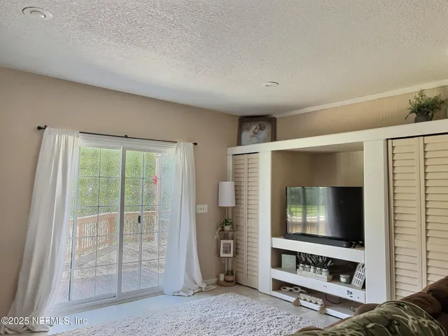a view of a patio with table and chairs a barbeque