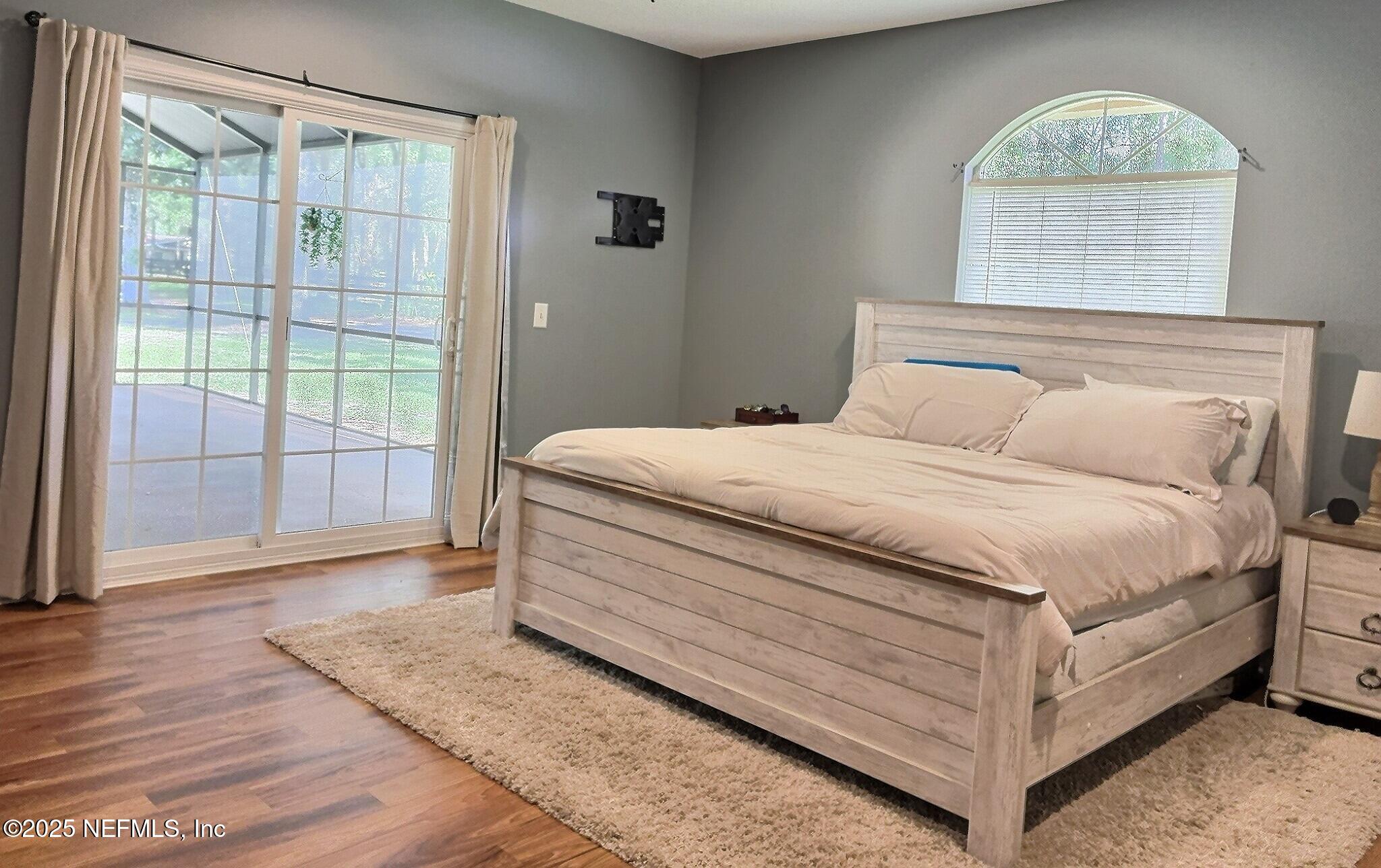 224 Crocus Lane Hawthorne, FL 32640 - Photo 23 of 58 a bedroom with a bed lamp and a large window