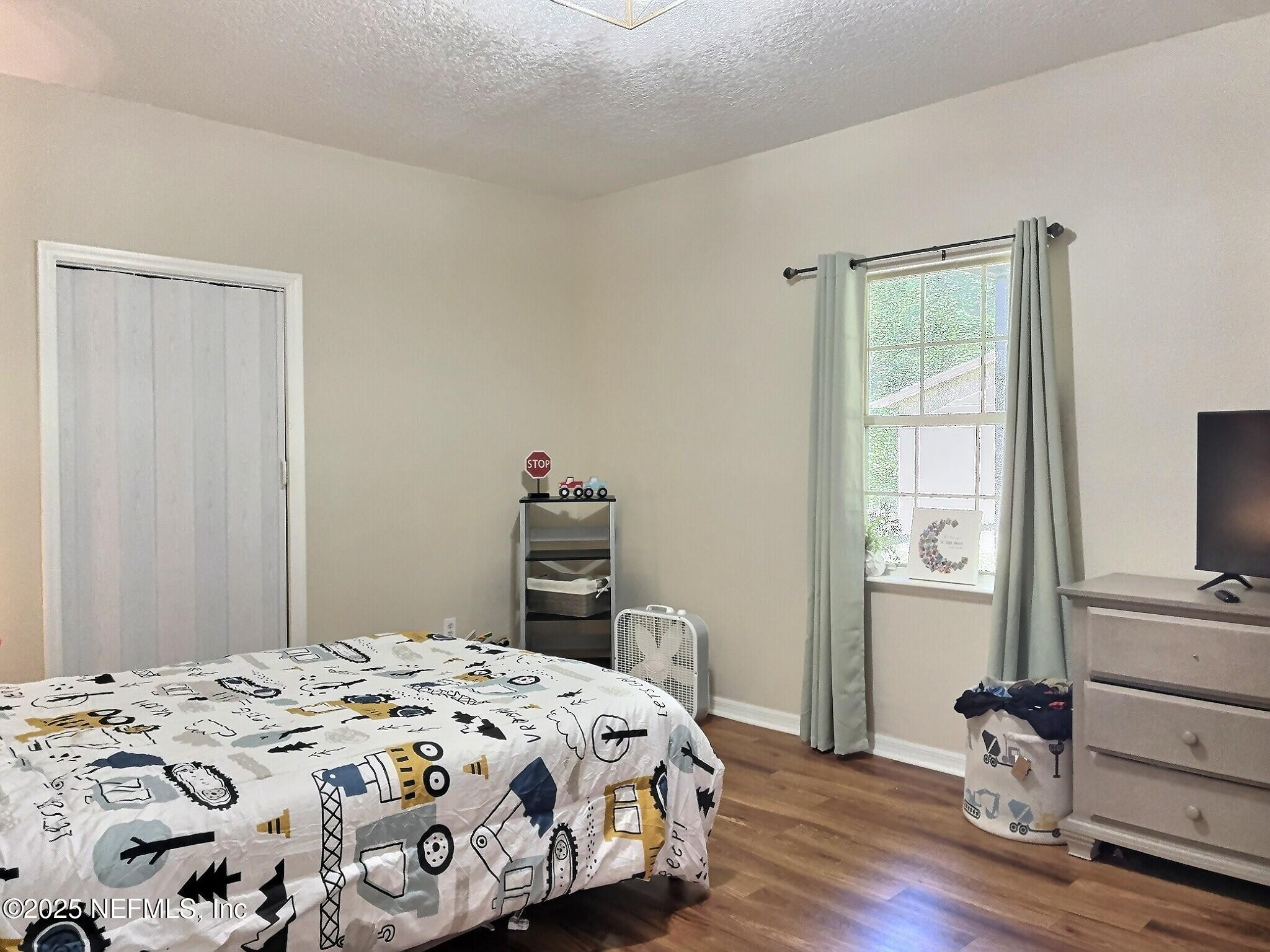 224 Crocus Lane Hawthorne, FL 32640 - Photo 30 of 58 a bedroom with a bed and wooden floor