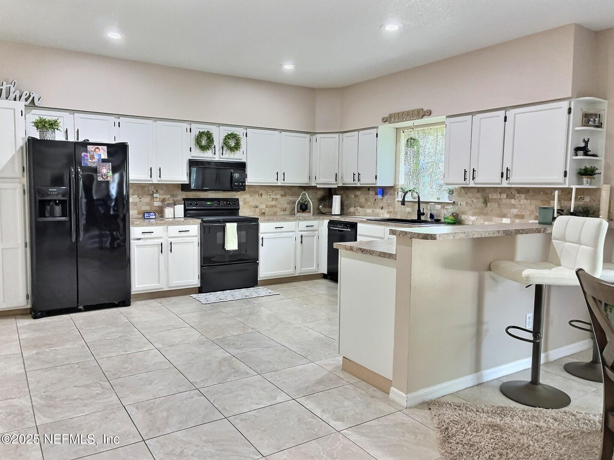224 Crocus Lane Hawthorne, FL 32640 - Photo 8 of 58 a kitchen with stainless steel appliances granite countertop a refrigerator sink and cabinets