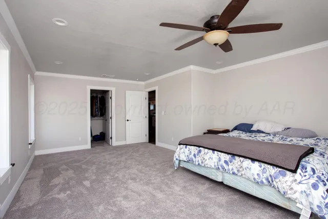 a bedroom with a bed and a ceiling fan