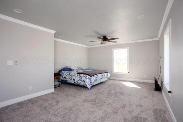 a spacious bedroom with a bed and a window