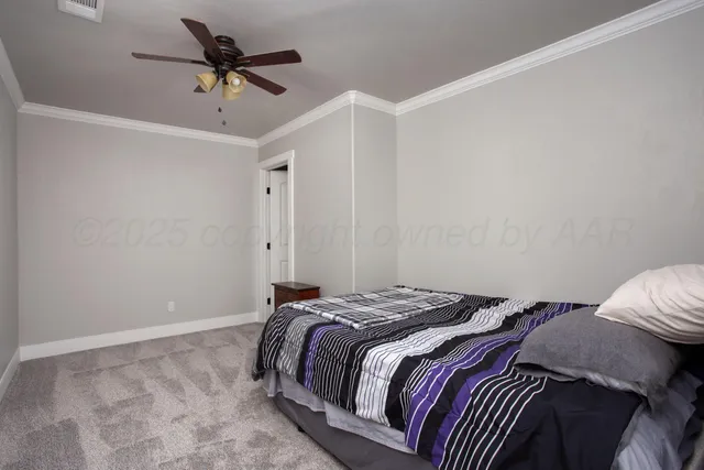 a bedroom with a bed and a ceiling fan