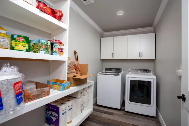a utility room with stainless steel appliances granite countertop a stove and cabinets