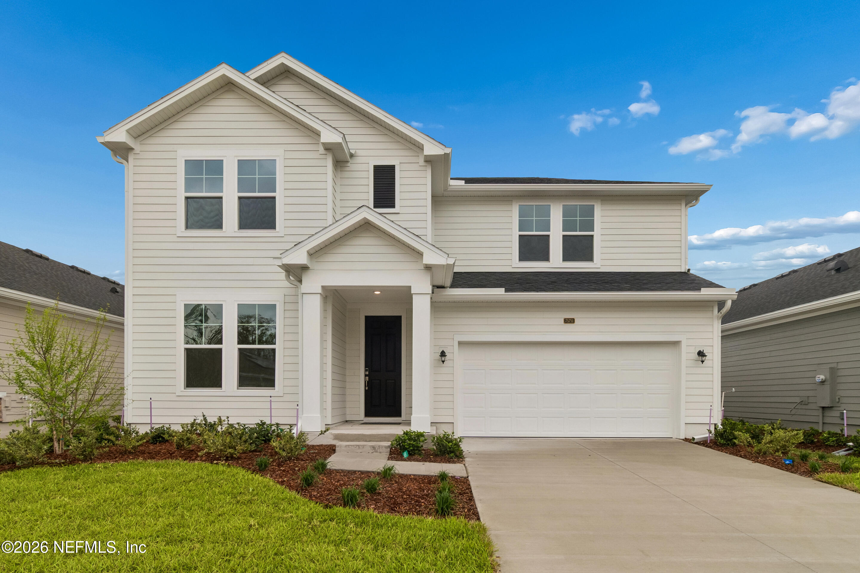 75751 Bayley Place Yulee, FL 32097 - Photo 1 of 28 a front view of a house with a yard and garage