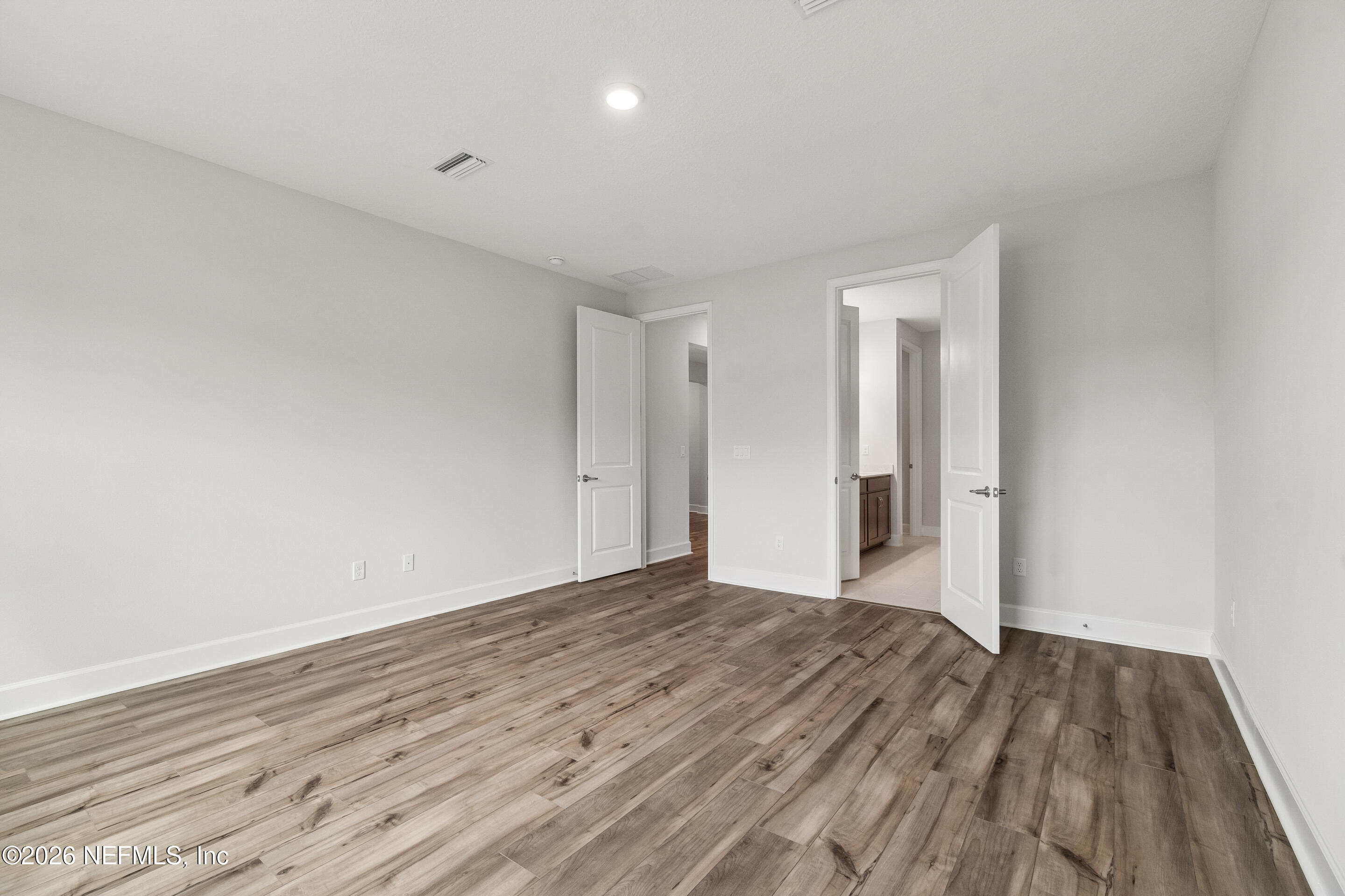 75751 Bayley Place Yulee, FL 32097 - Photo 15 of 28 a view of an empty room and wooden floor