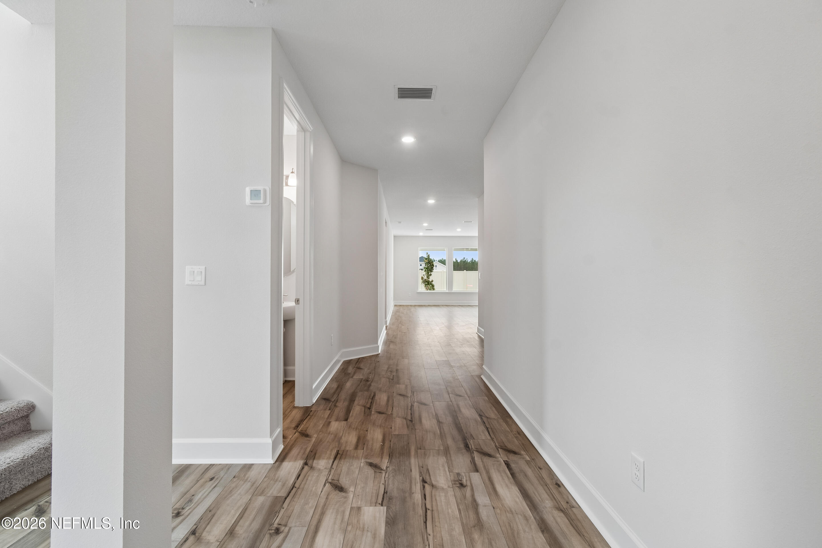 75751 Bayley Place Yulee, FL 32097 - Photo 16 of 28 a view of a hallway with wooden floor