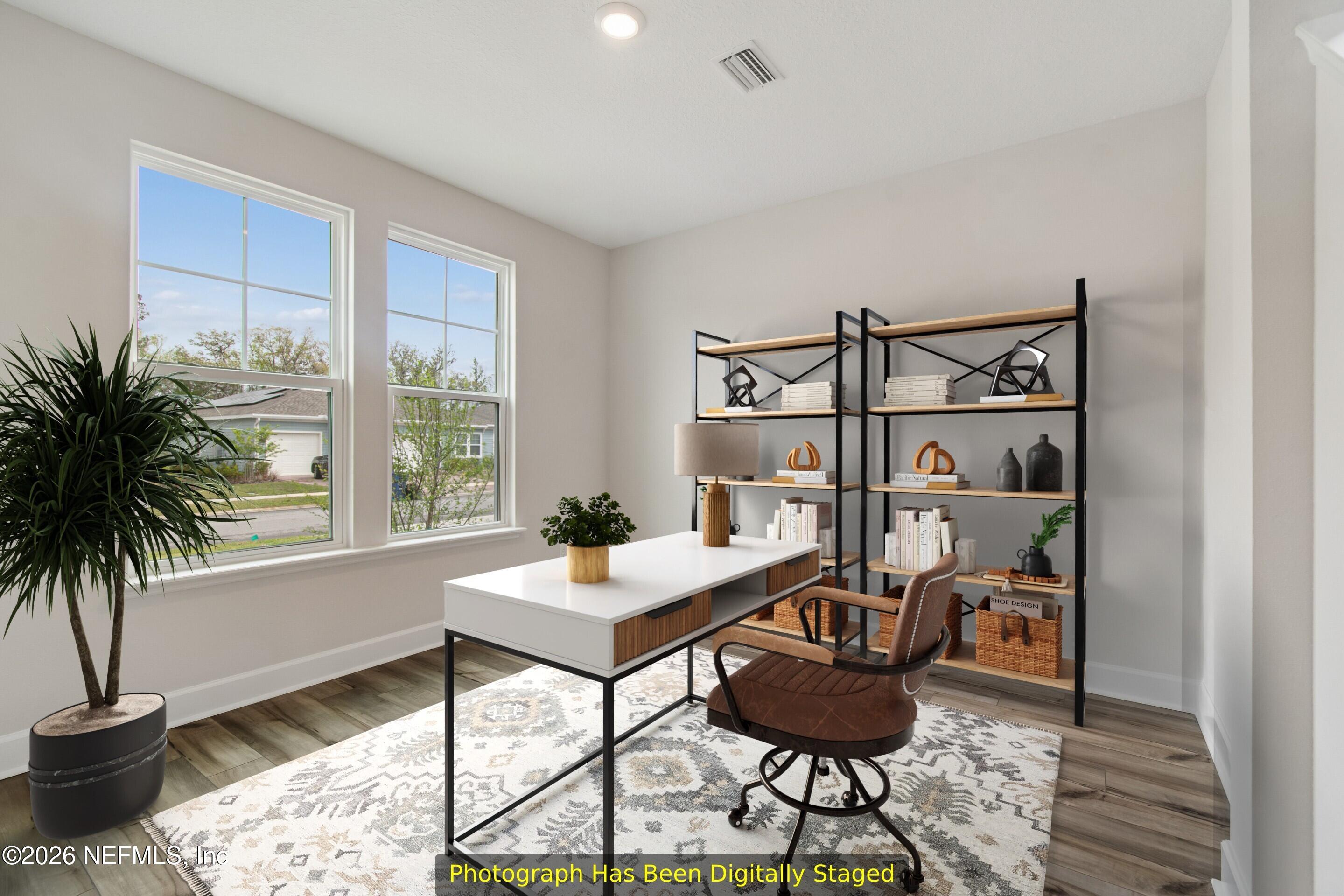 75751 Bayley Place Yulee, FL 32097 - Photo 18 of 28 a workspace with furniture and a potted plant