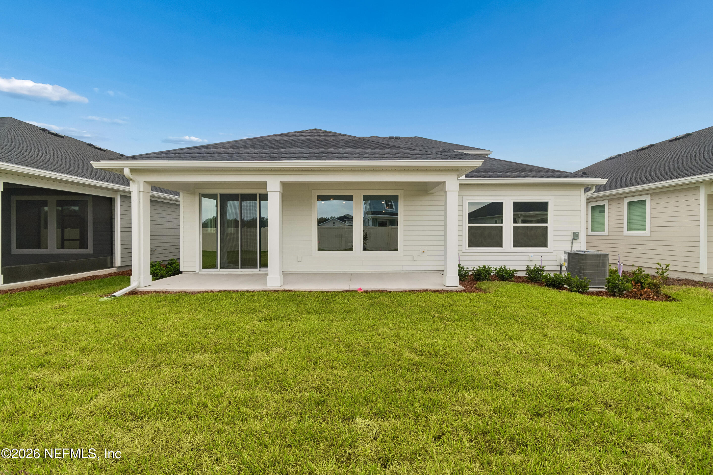 75751 Bayley Place Yulee, FL 32097 - Photo 20 of 28 a view of a house with backyard sitting area and garden