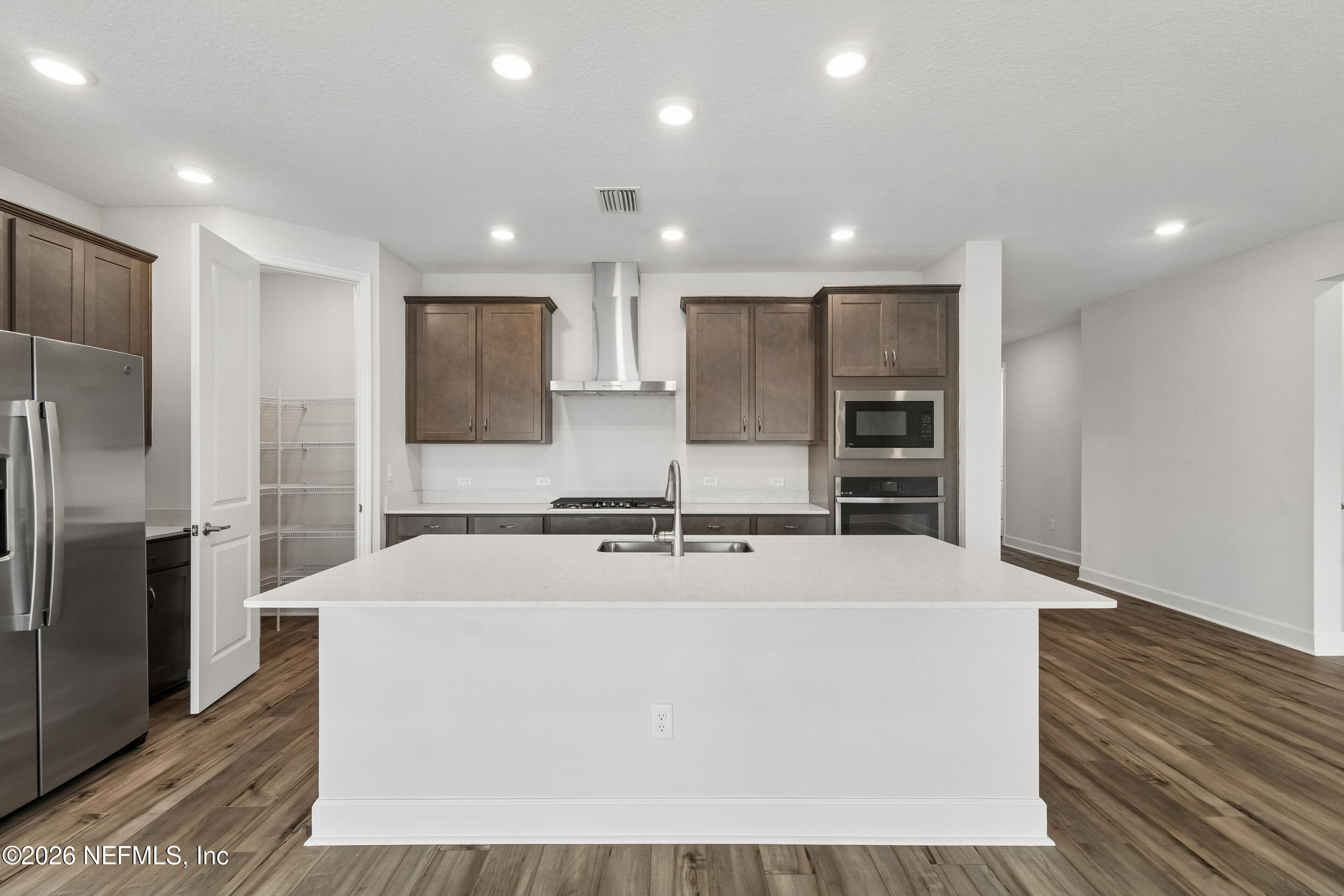 75751 Bayley Place Yulee, FL 32097 - Photo 2 of 28 a large kitchen with stainless steel appliances double vanity and a refrigerator
