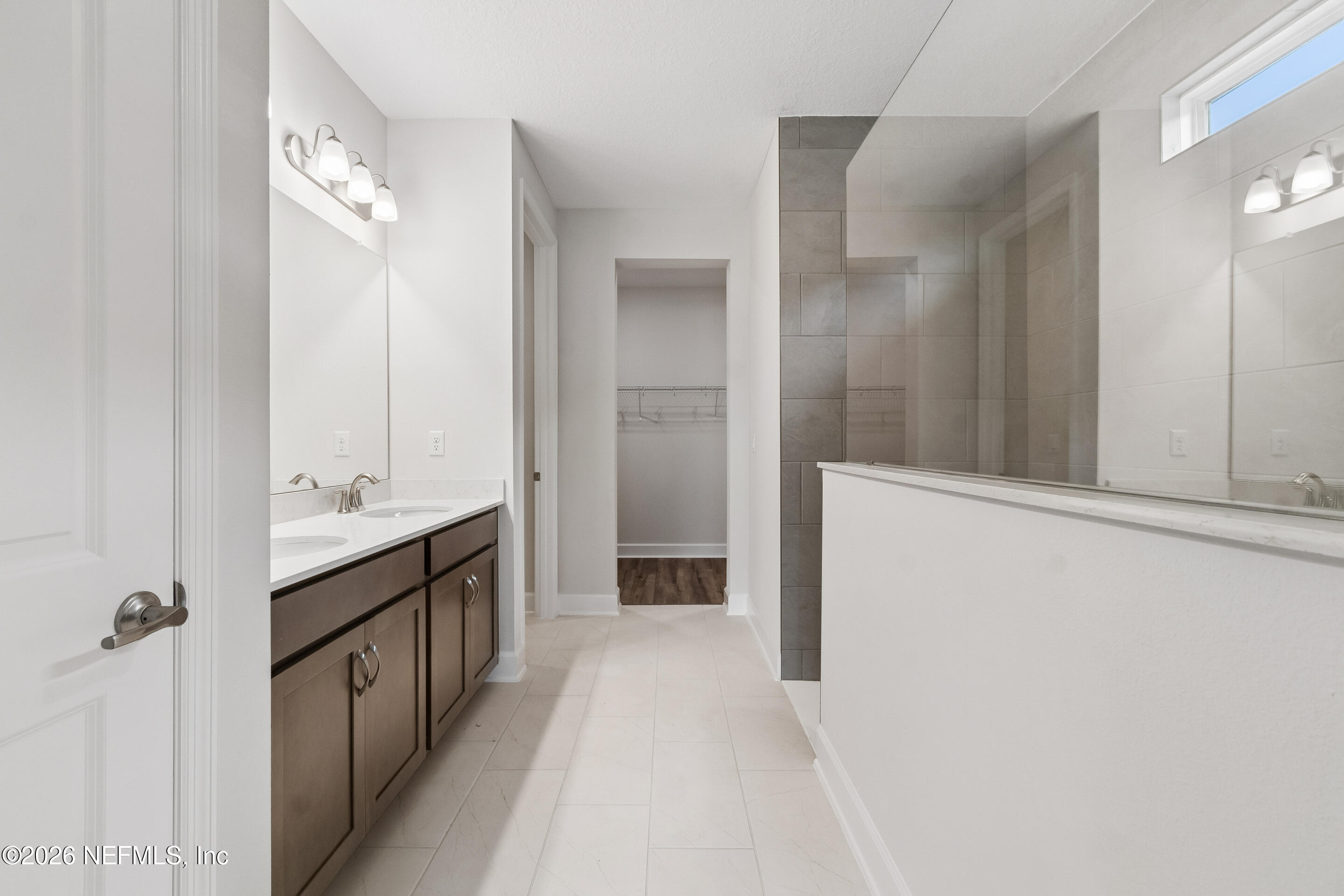 75751 Bayley Place Yulee, FL 32097 - Photo 23 of 28 a bathroom with a double vanity sink and mirror