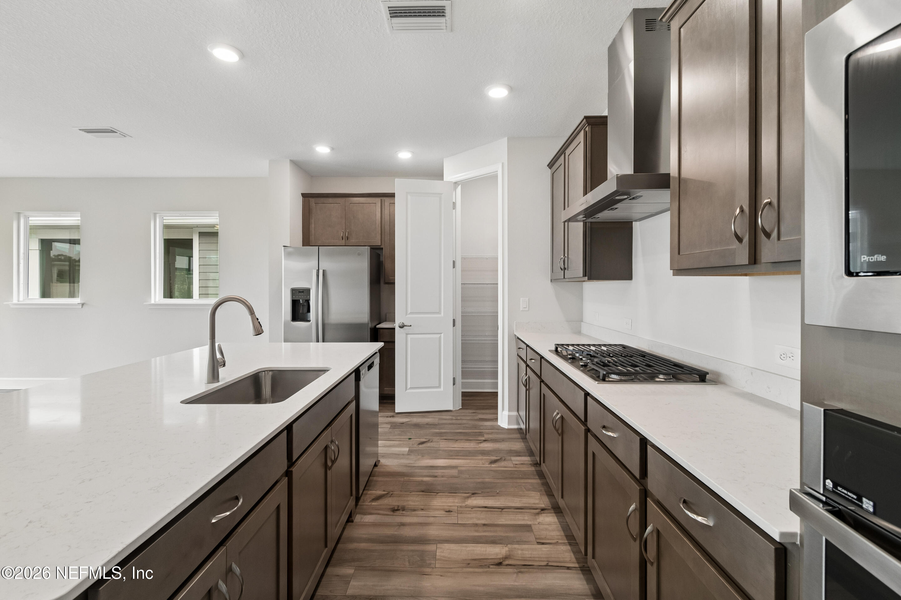 75751 Bayley Place Yulee, FL 32097 - Photo 4 of 28 a kitchen with stainless steel appliances granite countertop a sink a stove and a refrigerator